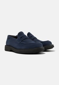 Blue suede loafers with a smooth finish, featuring a rounded toe and two decorative straps on the front. Black rubber sole for traction.