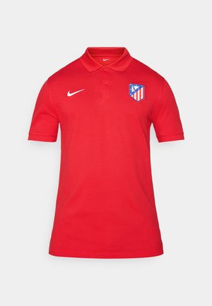 Rdeča polo majica z logotipom Nike in grbom ekipe na levem prsnem delu. Narejena iz gladkega materiala z ovratnikom in kratkimi rokavi.