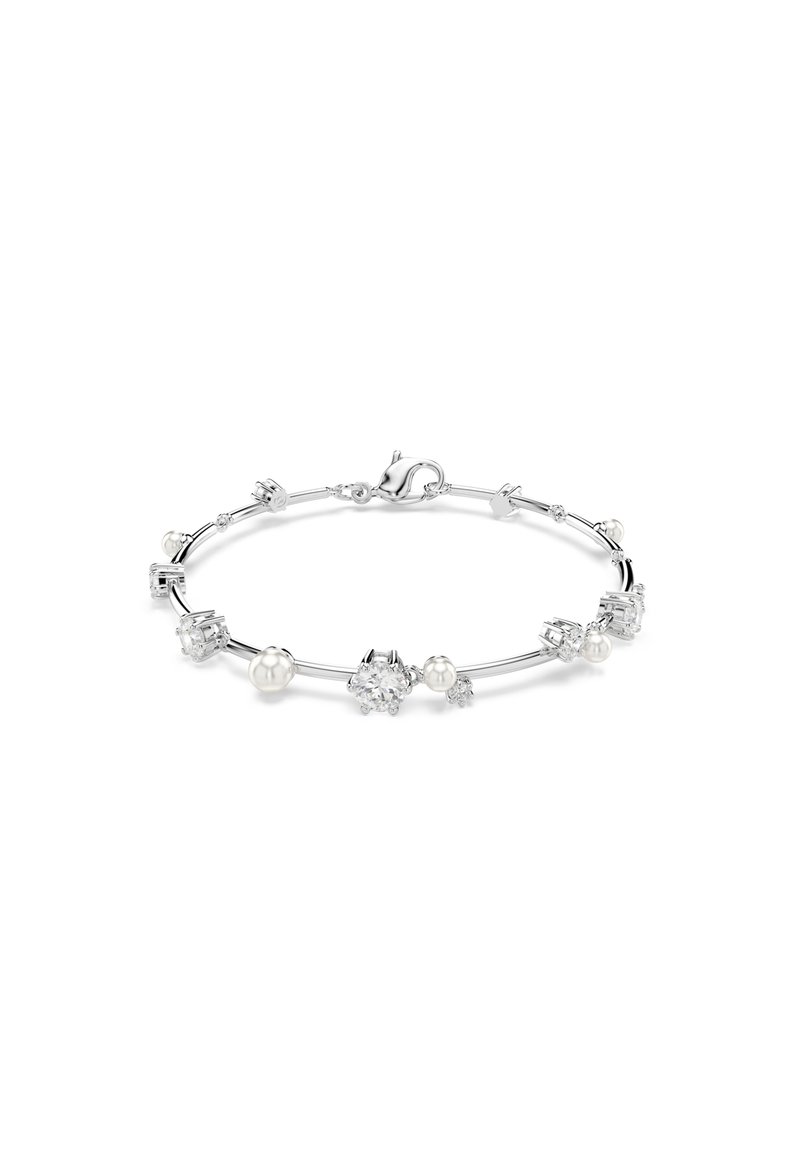 Srebrna narukvica z tanke, ukrivljene oblike, okrašena različitim prozirnim kamenjem i okruglim biserima, koja prikazuje mešavinu tekstura i oblika.