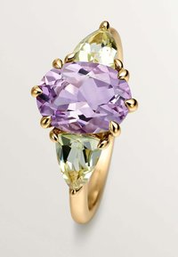 Anillo de oro con una gema ovalada morada y dos gemas verdes en forma de pera, con superficies lisas y engastes depuente.