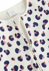 Langærmet baby bodystocking i creme med et farverigt abstrakt dyreprint. Har en frontlynlås og et blødt, struktureret stof.