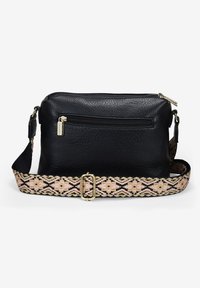 Bolso cruzado de cuero negro con una superficie texturizada, herrajes dorados y una correa beige y rosa con un patrón que presenta diseños geométricos.
