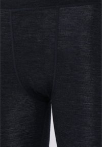 Marineblaue Leggings aus einem weichen, strukturierten Stoff; verfügen über ein enganliegendes Design und einen elastischen Bund mit dezenten Steppnähten.