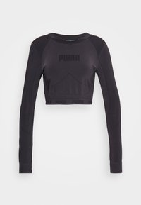 Lyhyeksi leikattu pitkähihainen paita mustana, jossa on sileä pinta, ribatut hihansuut ja hillitty "PUMA"-brändäys rinnassa ja helmassa.