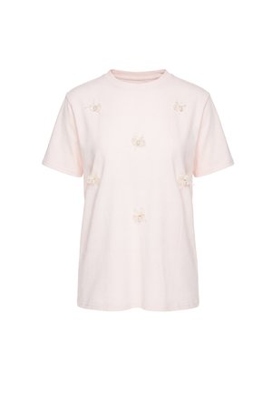 Lys rosa kortærmet t-shirt med seks dekorative stofsløjfer og perler fastsat på forsiden.
