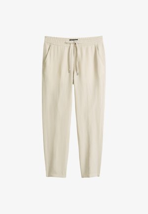 Beige casual broek met elastische tailleband, trekkoord, zijzakken en rechte pijpen, plat uitgestald op een witte achtergrond.