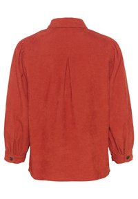 Chemise en velours côtelé rouille avec un empiècement au dos, manches longues et poignets boutonnés. Le tissu texturé et la coupe décontractée créent une silhouette casual.