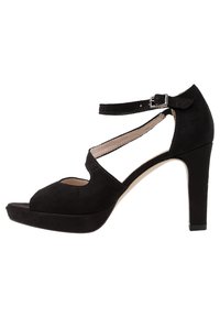 Svart mocka högklackad sandal med ankelrem, öppen tå, utskärningsdesign och plattform för extra höjd.