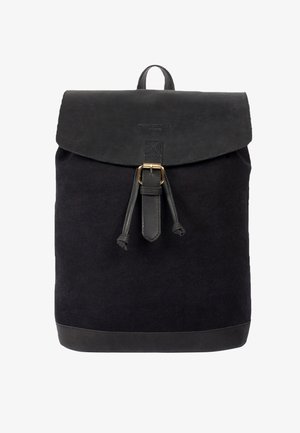 Black canvas backpack with a leather flap, metal buckle closure, and a textured finish. Features a pull string and reinforced bottom.