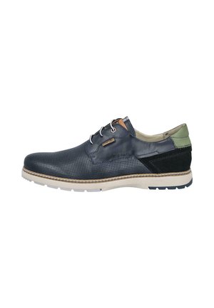 Zapato casual negro de cuero para hombre con parte frontal perforada, parche verde en el talón, cierre de cordones y suela blanca con detalles cosidos.