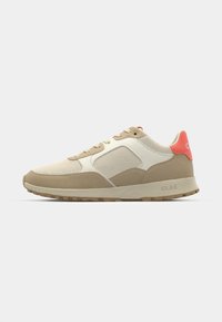 Beige and cream sneaker with mesh and suede materials, rubber sole, accentuated by a coral heel tab and subtle logo detail on the side.