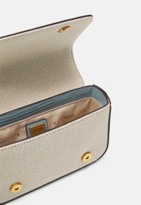 Texturovaná béžová peněženka se zlatými detaily, modrou vnitřní podšívkou a více oddíly pro organizaci. Obsahuje uzávěr na patent.