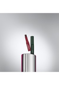 Clinique leppeprodukt og eyeliner i en sølvbeholder. Leppeproduktet er dyp rød, og eyelineren er mørk grønn med en matt finish.