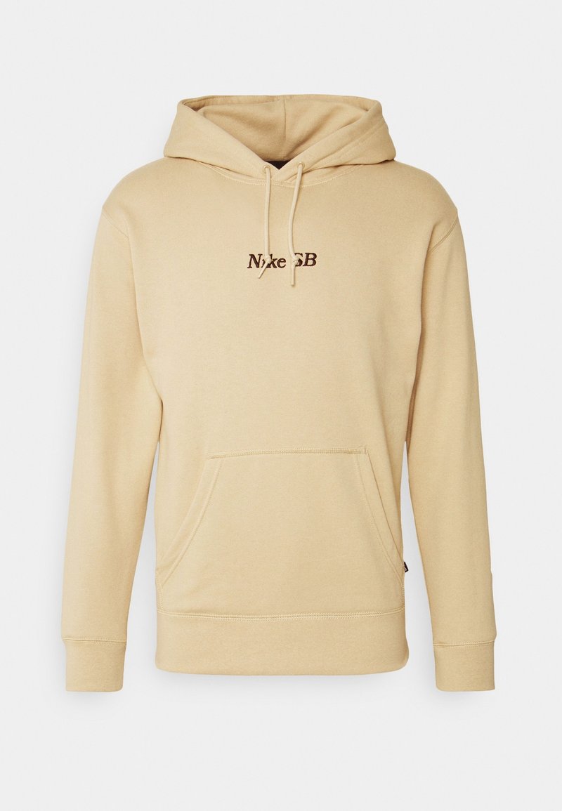 Sweat à capuche beige Nike SB avec poche kangourou sur le devant, capuche avec cordon et petit logo Nike SB marron centré sur la poitrine.