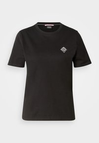 T-shirt in cotone nero con scollatura rotonda, maniche corte e un piccolo design grafico bianco sulla parte sinistra del petto.