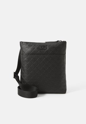 Black leather crossbody bag with a textured pattern, zip closure, and adjustable strap featuring embossed branding.