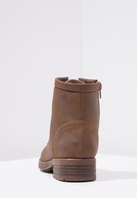 Brown leather ankle boot with a smooth finish, round toe, and a low stacked heel; features a side zipper for easy wear.