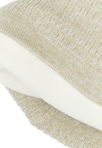Berretto a maglia beige e crema, con un motivo a coste testurizzato e fodera in morbido fleece per calore e comfort.