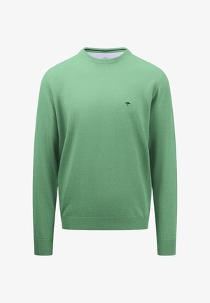 Zöld kötött pulóver hosszú ujjal, kerek nyakkal és fekete fa logóval a mellkasán. Sima textúrájú, bordázott mandzsettákkal és alsó szegéllyel.