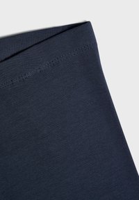 Marineblå elastisk stoff med en glatt tekstur og en pent ferdig beltelinje, perfekt for komfortabelt bruk.