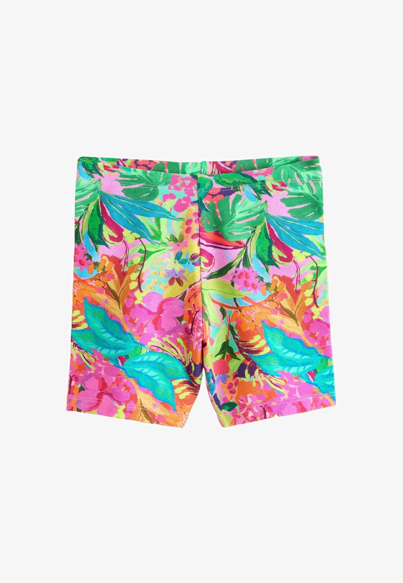 Shorts à imprimé tropical éclatant avec des feuilles et des fleurs vertes, bleues, roses et orange sur un fond rose.