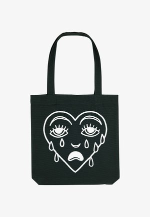 Zwarte canvas draagtas met een wit geborduurd hartontwerp met ogen en tranen, met een gladde textuur en stevige handvatten.