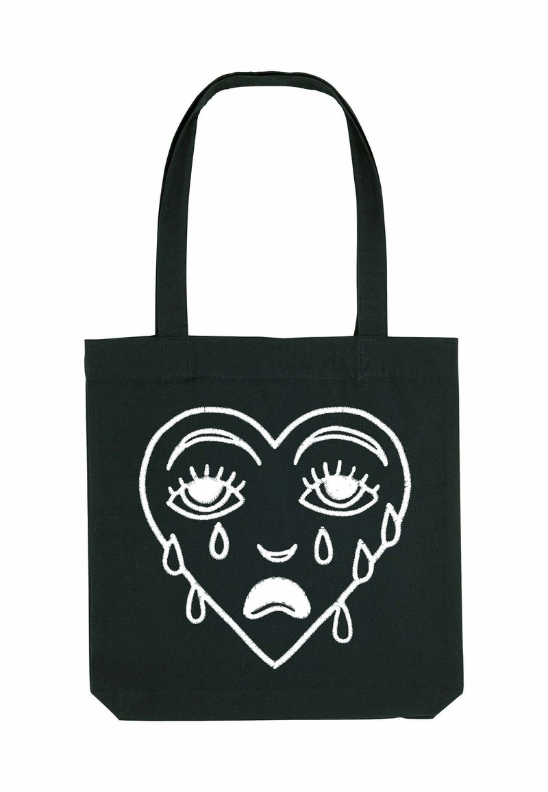 Zwarte canvas draagtas met een wit geborduurd hartontwerp met ogen en tranen, met een gladde textuur en stevige handvatten.