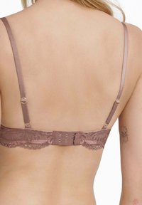 Spitzenbügeltasche in sanftem Mauve mit satinierten Trägern, verstellbarem Verschluss und gewelltem Spitzenbesatz entlang des Bands.