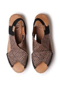 Woven smeđe i crne kožne sandale s križnim trakama, otvorenom petom i podstavljenom unutarnjim dijelom; šivani detalji oko rubova.