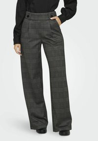 Black and gray plaid high-waisted wide-leg trousers with two front pockets and button accents on the waistband. Smooth fabric texture.