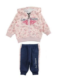 Sweat à capuche zippé rose avec motif floral et texte « Lee Cooper », associé à un pantalon de jogging bleu marine avec une bande latérale rose clair.