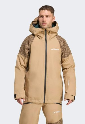 Light brown waterproof jacket with textured brown accents, high collar, and zippered front. Features black hardware and logo on chest.