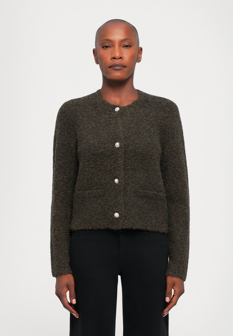 Dark green textured cardigan with a round neckline, five shiny buttons, and two front pockets. Soft fabric and cropped design.