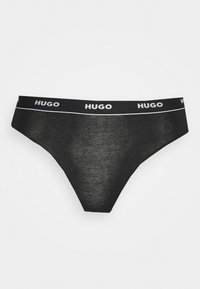 String noir en coton avec une taille élastique douce arborant le logo embossé "HUGO" en blanc, conçu pour un ajustement parfait.