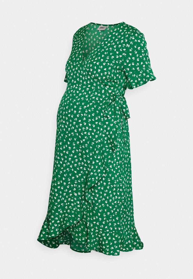 Robe de maternité portefeuille verte à motif floral blanc, manches courtes, col en V, ceinture à nouer sur le côté, longueur genou avec ourlet volanté.