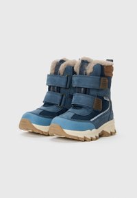 Blauwe winterlaarzen van gestructureerd leer en stof, met twee verstelbare bandjes, een voering van bont en een robuuste beige zool.