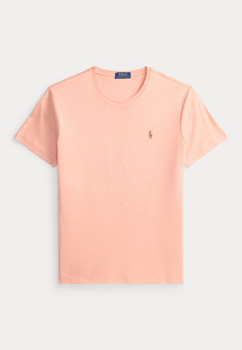 T-shirt Polo Ralph Lauren à manches courtes de couleur rose clair, avec col rond et petit logo de joueur de polo brodé sur la poitrine gauche.