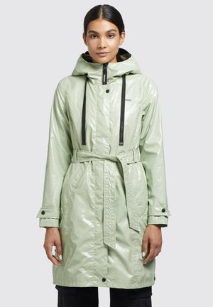 Light green, shiny raincoat with a hood, belted waist, black accents, snap buttons, and elastic drawstrings around the neck.