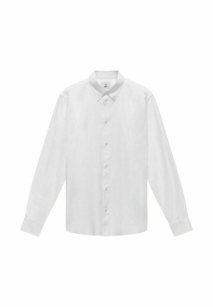 Chemise blanche à manches longues, avec un tissu lisse. Équipée d'un col pointu, d'une fermeture à boutons sur le devant, et d'une coupe droite.
