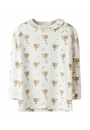 Light cream long-sleeve top featuring a ruffled neckline and a floral pattern with golden accents and small illustrations. Soft fabric texture.
