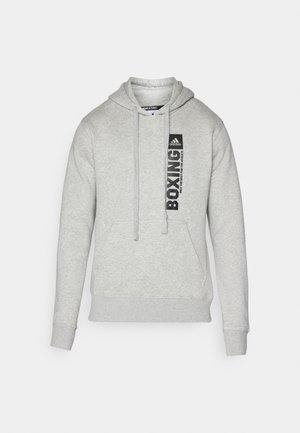 Vaaleanharmaa puuvillahuppari, jossa on etupuolella kengurun tasku, kiristettävä huppu ja rintaosassa painettu "BOXING" -grafiikka.