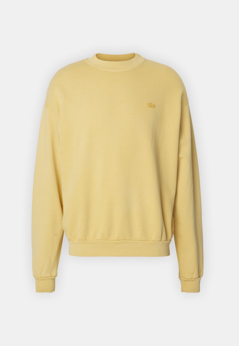 Geel sweatshirt van zachte stof met ronde hals, ribgebreide manchetten en onderkant. Bevat een klein geborduurd logo op de borst.