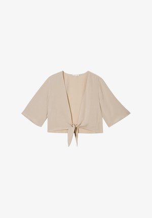 Top cropped beige con mangas anchas, escote en forma de V y cierre con lazo en el frente. Fabricado en una tela suave y ligera con una textura lisa.