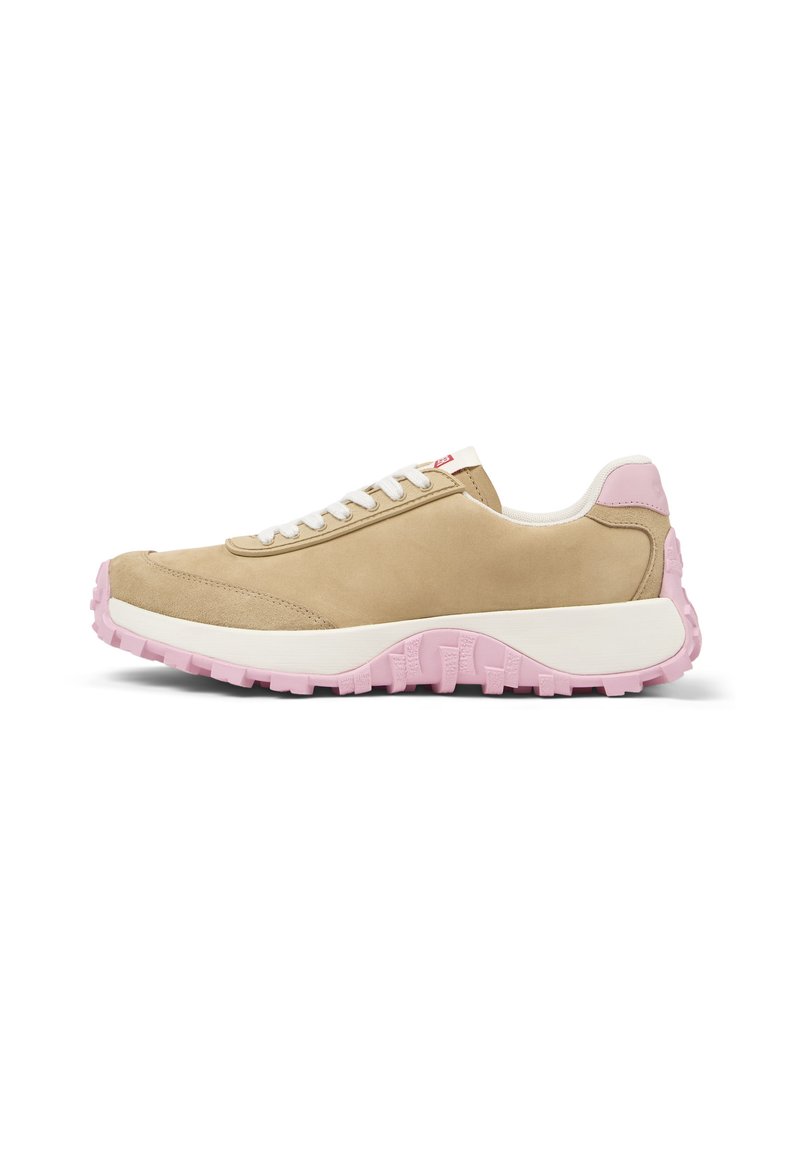 Beige suede sneaker with white laces and a pink accent on the heel. Thick, textured pink rubber sole and minimalistic design.