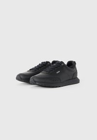 Pair of black low-top sneakers with laces and subtle branding on the side, displayed on a white background.