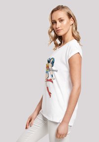 White cotton t-shirt featuring a colorful graphic of a female superhero with blue hair, red boots, and vibrant accents on a relaxed fit design.