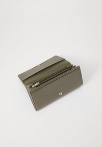 Olive-green leather wallet with a textured finish, featuring a snap closure and multiple compartments, including a zippered section.