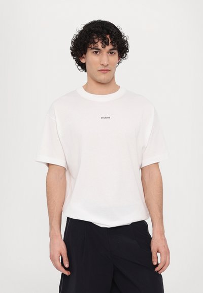 Tricou alb din bumbac cu mâneci scurte și decolteu rotund, cu "soulland" imprimat în negru în centru. Design minimalist selectiv.