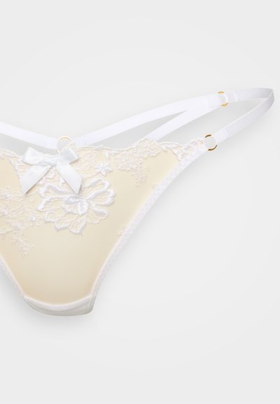 Világos sárga színű, virágos csipkedíszítésű női alsónemű tangához hasonló alsó, fehér pántokkal és egy kis szatén masnival díszítve. Arany színű fémkellékekkel.