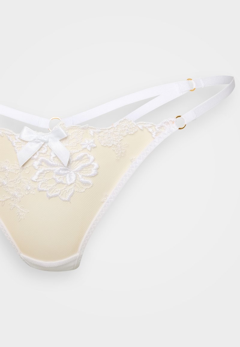 Trosa i ljusgult med blomsterbroderad spets, vita band och en liten satinrosett. Har guldfärgade detaljer.